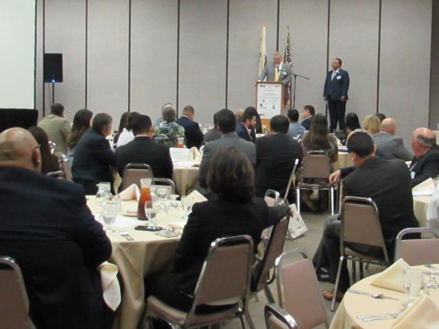 Audience attending lunch and presentation in large dining hall